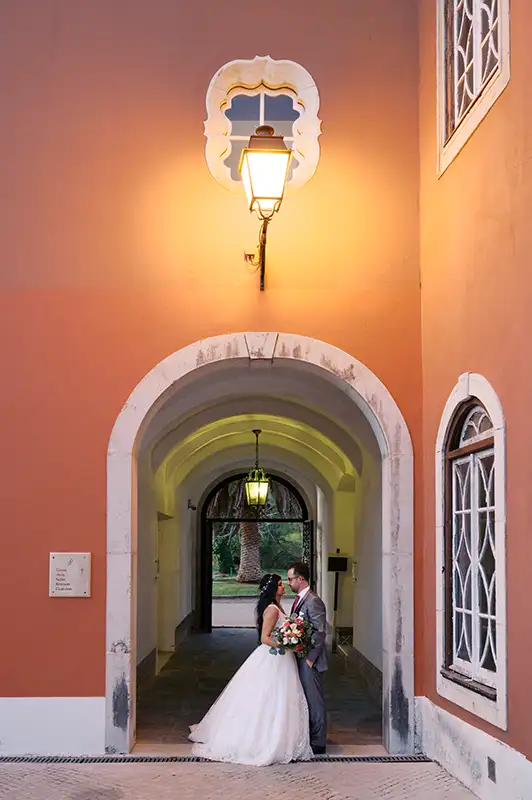 Wedding couple on their wedding day in a relaxed photo session at the Penha Longa resort in Sintra - Cascais under a lamp.