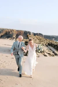 Wedding couple running on the beach at sunset in Cascais at Arriba by the Sea.