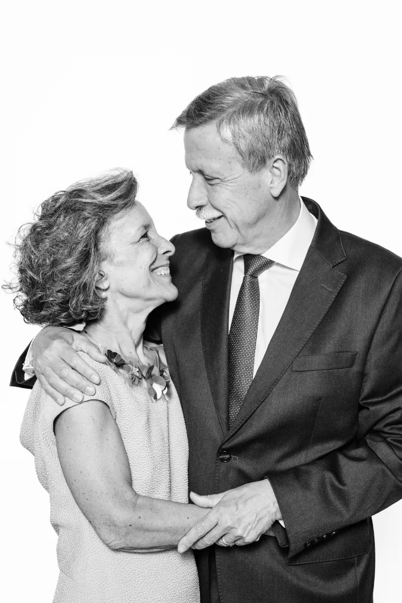 Black and white portrait of an elderly couple with a tender and happy smile, captured with studio lighting at the Portrait Station.